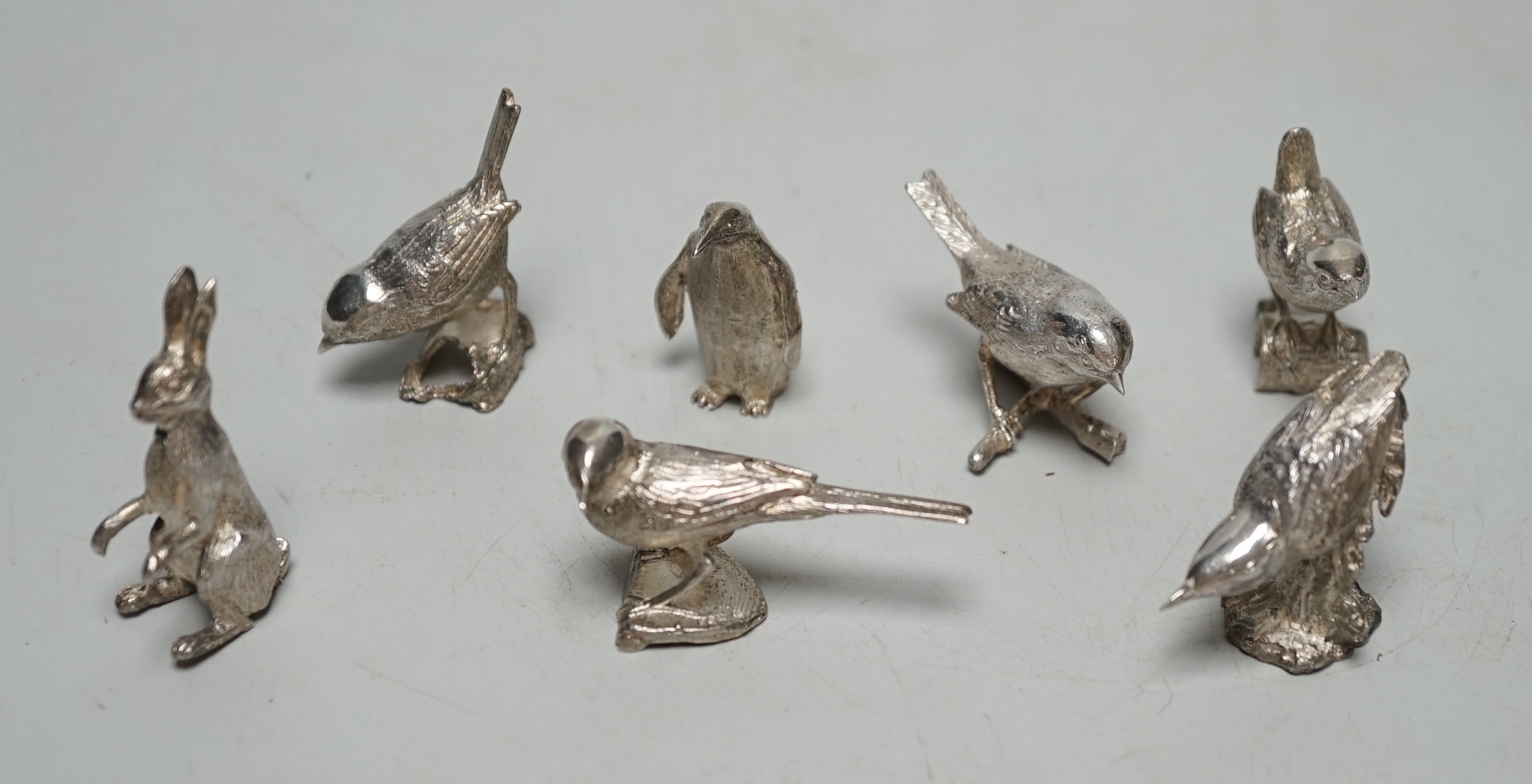 A small collection of seven 1980's/1990's miniature silver models, by Paul Eaton, comprising five birds, a rabbit and a penguin, tallest 43mm.